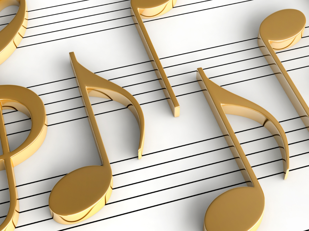 large gold 3d musical notes on a black and  white music sheet