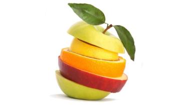 Stack of variety fruit slices in shape of an apple, leaves and stem at top