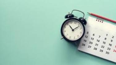 Clock & Calendar picture of an old fashioned clock and regular calendar with blue background