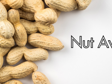 a pile of shelled peanuts on a white background, words say "nut awareness"