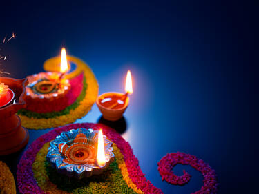 Diwali  lit candles on a dark blue background