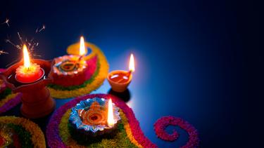 Diwali  lit candles on a dark blue background