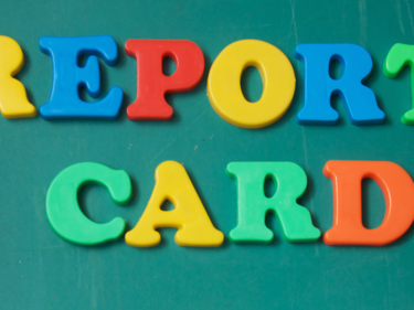 Report Card written in colours against green background