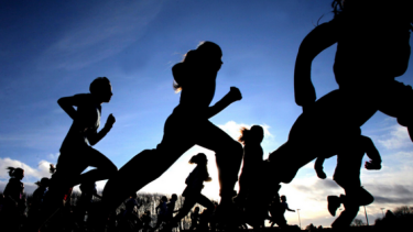 variety of people in running motion, all dark with blue sky in blackground
