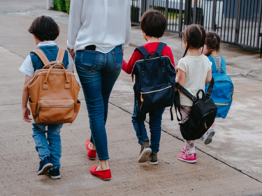 Kids walking to school with a parent