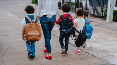 Kids walking to school with a parent