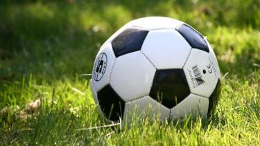 Black & white soccer ball on green grass