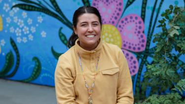 Young female teacher sits and smiles