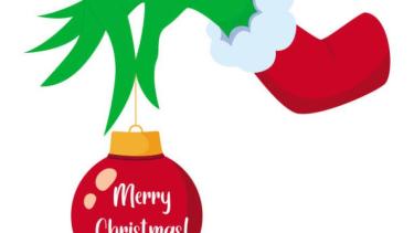 Grinch hand holding a red xmas tree ornament that says Merry Christas