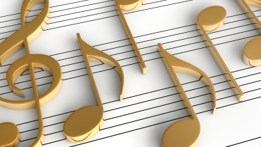 large gold 3d musical notes on a black and  white music sheet