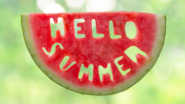Watermelon with Hello Summer words cut out of it Hello Summer