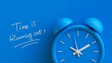 Time is Running out spelt out on blue background with picture of blue ticking clock Time is Running Out