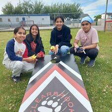 Students playing Mouat cornhall game on elementary school field