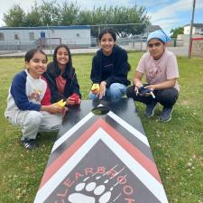 Students playing Mouat cornhall game on elementary school field