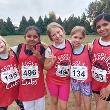 Elementary students posing in school field after track & field practice