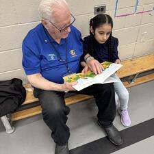 A Student Reading with a community volunteer