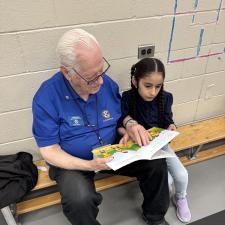 A Student Reading with a community volunteer