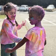 Elementary students throwing coloured powder for Holi celebration