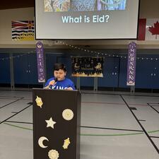 Student Speaker in Gym at Elementary Eid Assembly
