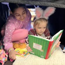 Girls Reading Under a desk