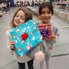 Students showing the gifts they purchased at Elementary christmas market